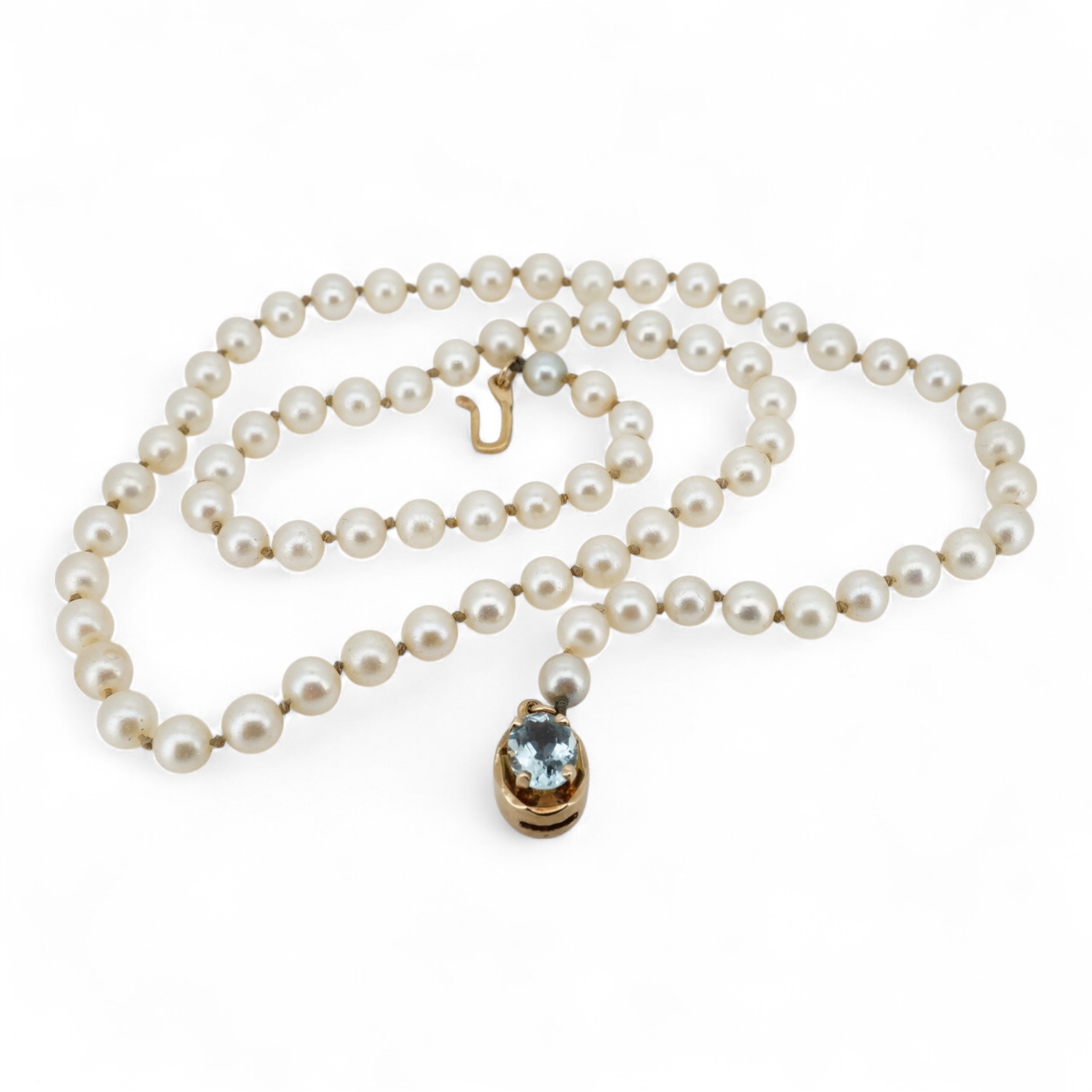 A cultured pearl and aquamarine necklace, composed of a single strand of cultured pearls, to a gold clasp set with an oval aquamarine, length 53.5cm, Condition: in good condition, minor wear, minor variations in pearl co